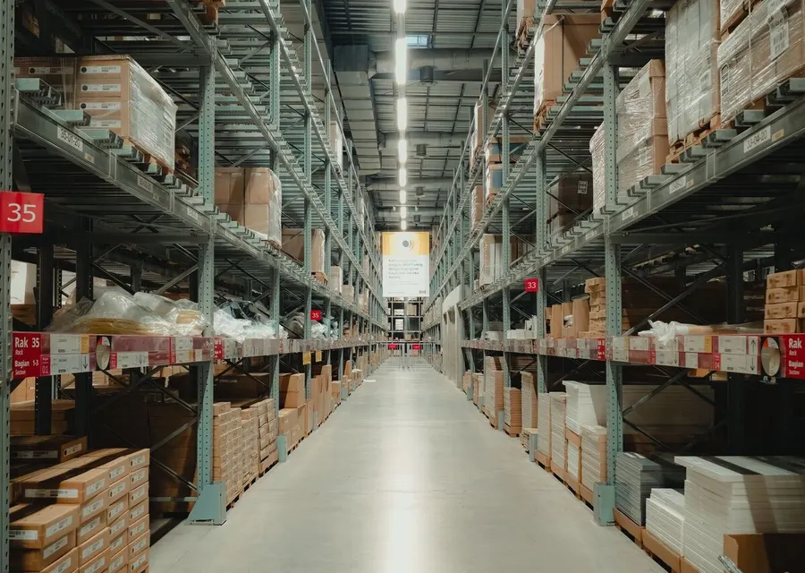 A long warehouse aisle of stocked racking